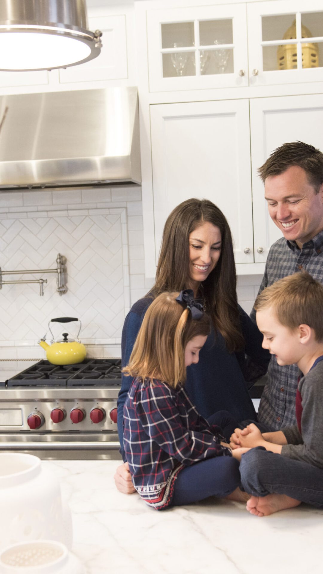 Couple and two children chatting in kitchen